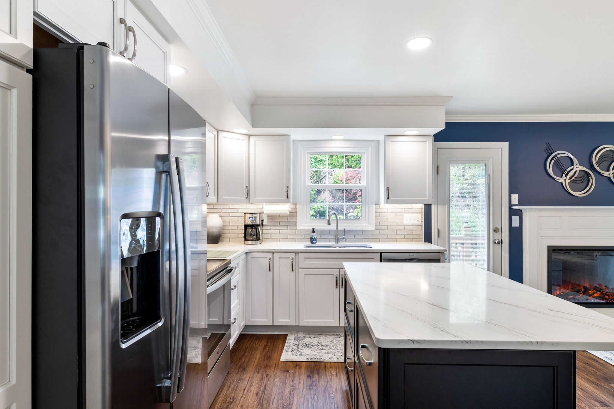 Kitchen renovation with white cabinets and quartz island