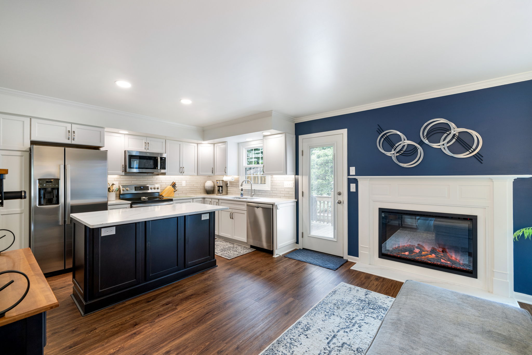 Open concept kitchen remodel with white cabinets