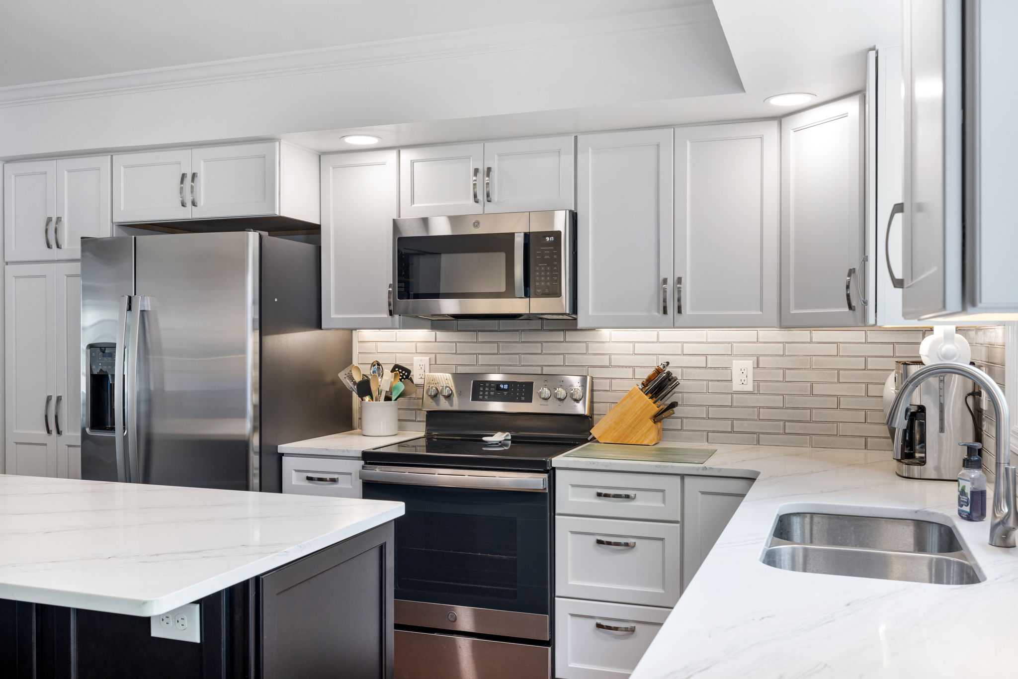White cabinet kitchen with stainless steel appliances